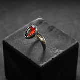 custom made ring, unique piece, contemporary design, red gold and black silver with a garnet center stone