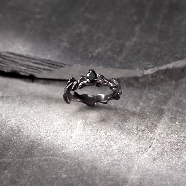 Solitaire ring in black gold and pear-shaped black diamond