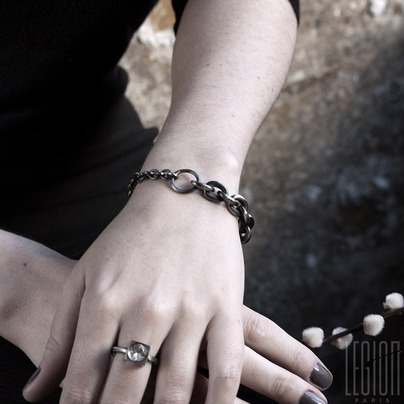 woman's hand wearing a black silver chain bracelet