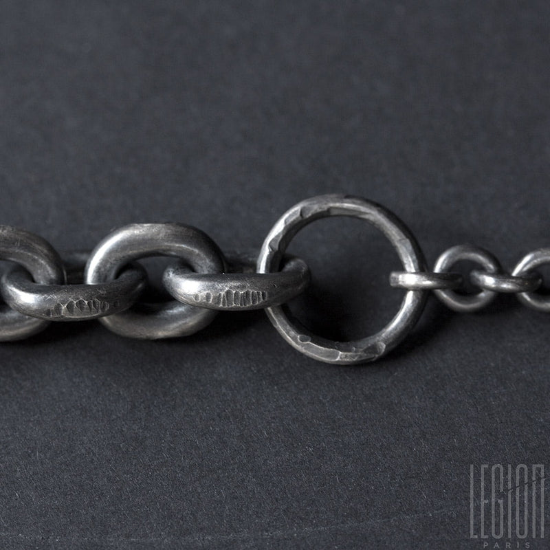 Detail of a silver bracelet with two chains of different sizes