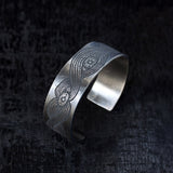 wide silver bracelet with engraved design