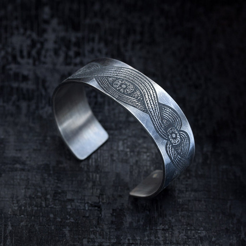 side view of a cuff with black silver engraving