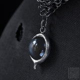 Side view of a grey moonstone on a black silver 925 Legion Paris chainmail necklace