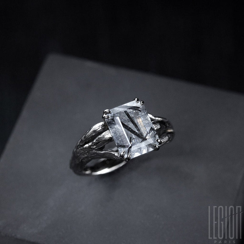 side view of a white gold Legion Paris engagement ring with a center stone 