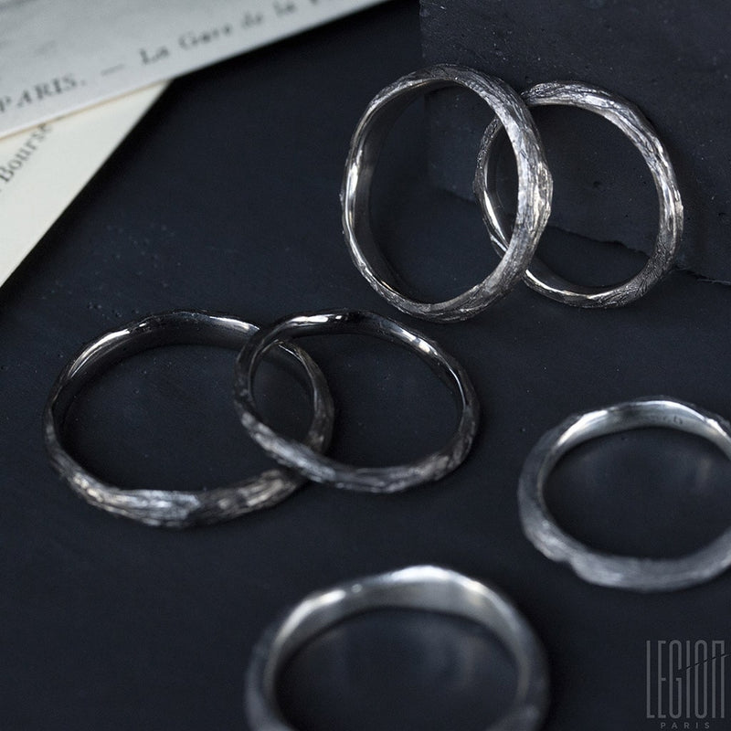 set of wedding rings in black silver, black gold and white gold