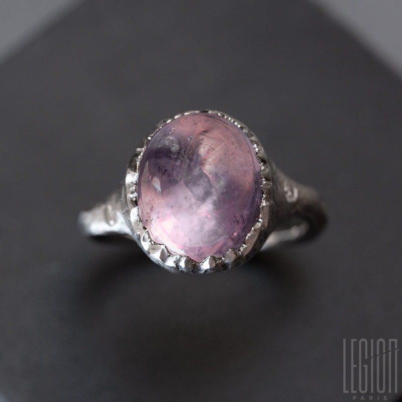 Textured white gold signet ring with a large pink tourmaline cabochon set with small claws that look like an eggshell