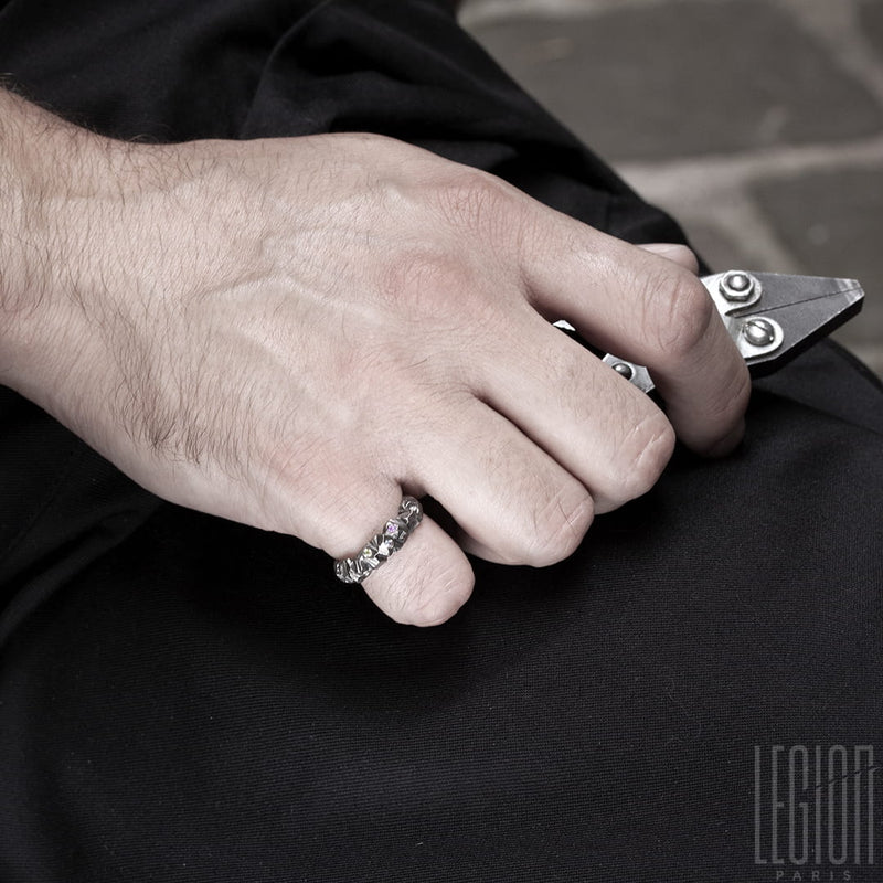 man's hand wearing a white gold textured ring on his little finger