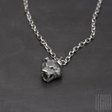 black silver pendant representing a bear head with two black diamonds in place of the eyes on a black silver diamond forçat chain