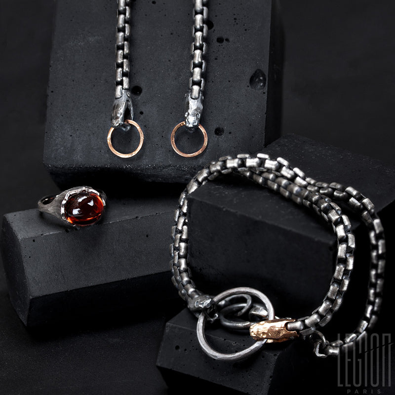 black silver and red gold earrings representing a snake body