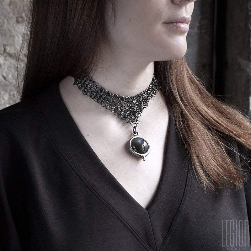 woman wearing a black silver chain mail necklace with a large black moonstone pendant 