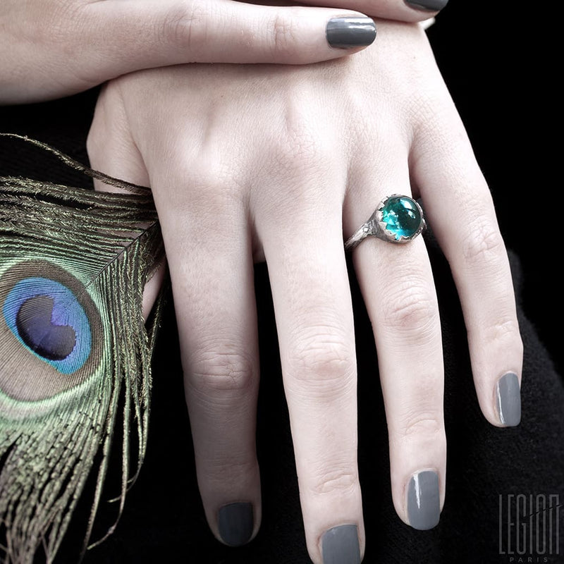 woman's hands wearing a silver ring with a blue tourmaline
