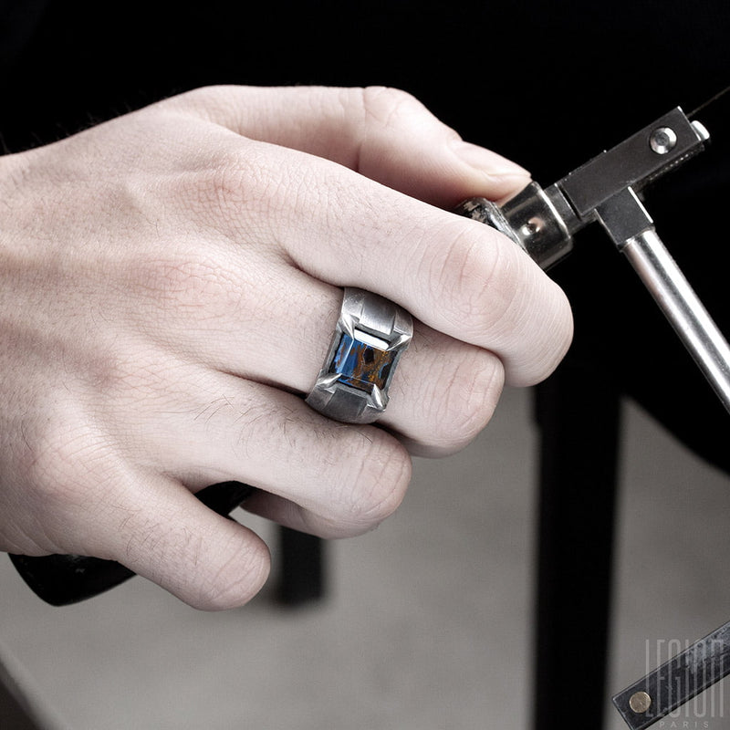 hand of man wearing a signet ring Legion paris in black silver and piertersite